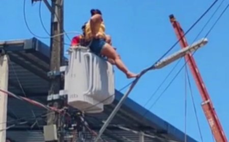 Mulher escala poste e sobe em transformador de energia