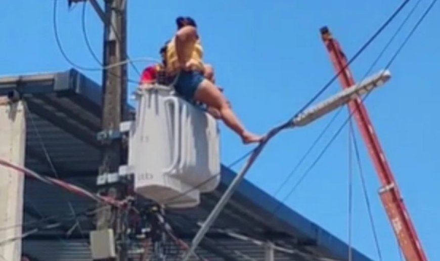 Mulher escala poste e sobe em transformador de energia