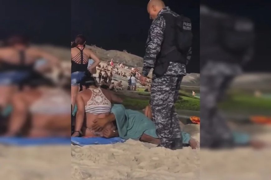 Homem faz sexo oral em mulher no meio de praia lotada.